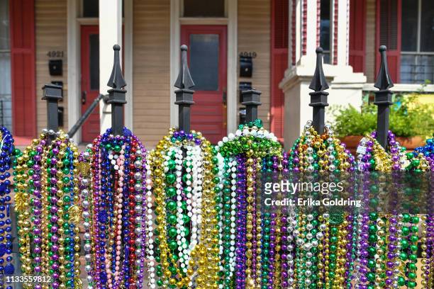 Mardi Gras beads decorate a wrought iron fence on Magazine Street on March 3, 2019 in New Orleans, Louisiana.