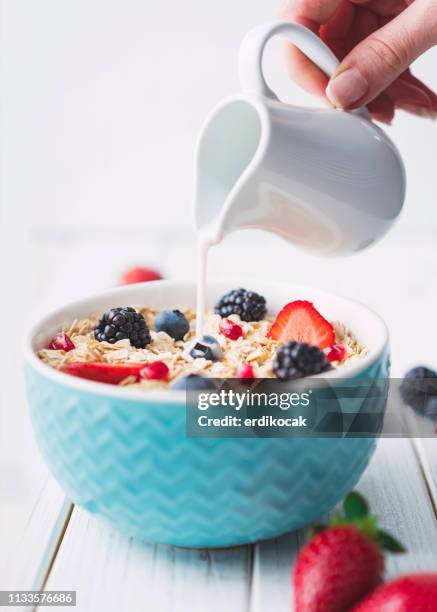 muesli with fruit and milk - pouring cereal stock pictures, royalty-free photos & images