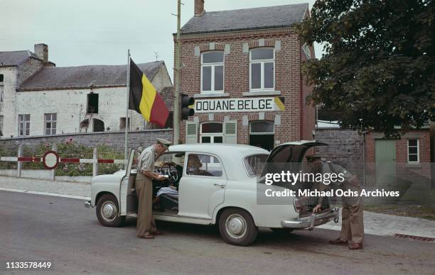 Belgian customs officials making checks on a car at Heer in Belgium, near the border with France, circa 1960.