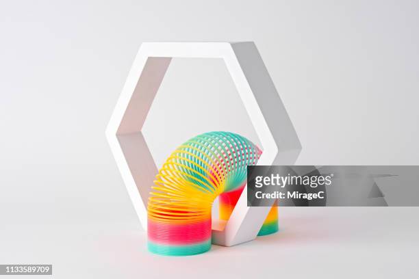 flexible coil crossing hexagon frame - flexible concept stock pictures, royalty-free photos & images