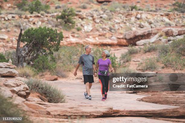 senior couple hiking in the desert - hiking utah stock pictures, royalty-free photos & images