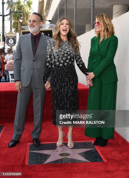 Tom Hanks, wife Rita Wilson, and Julia Roberts stand on Wilson's newly unveiled star after she was honored on the Hollywood Walk of Fame in...