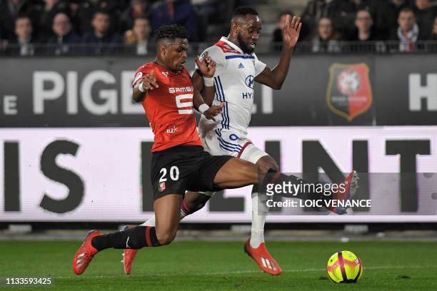 Lyon's French forward Moussa Dembele vies with Rennes' French defender Gerzino Nyamsi during the French L1 football match Stade Rennais vs Olympique...