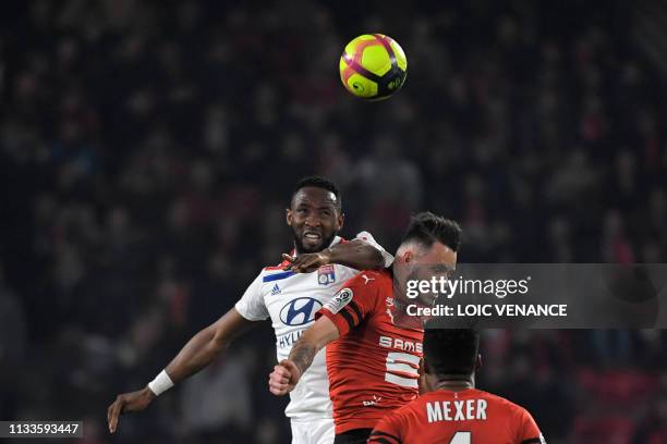 Lyon's French forward Moussa Dembele vies with Rennes' French defender Jeremy Gelin during the French L1 football match Stade Rennais vs Olympique...