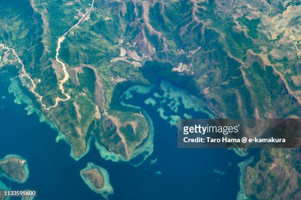 sulu sea and coral-colored islands in philippines daytime aerial view from airplane - philippines aerial stock pictures, royalty-free photos & images