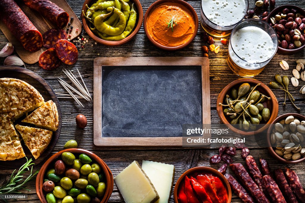 Tapas and beer: typical spanish food shot from above making a frame
