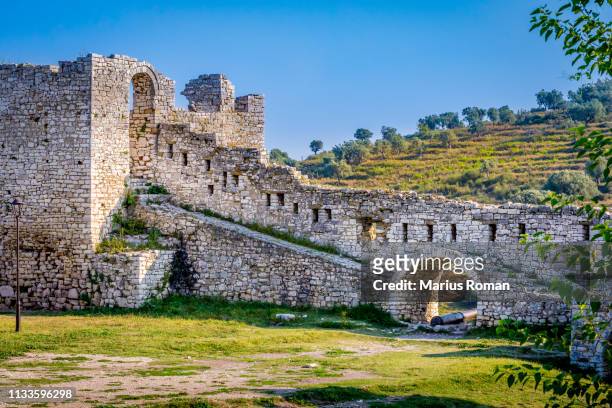 view of a the defensive stone wall in the fortified city of berat, albania, unesco world heritage site. - albanië stockfoto's en -beelden