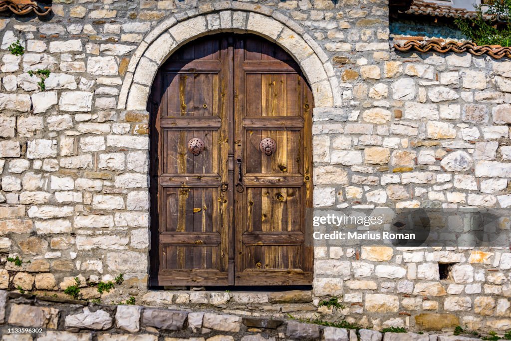 Typical arched wooden door in the old fortified city of Berat, Albania, Unesco World Heritage Site.