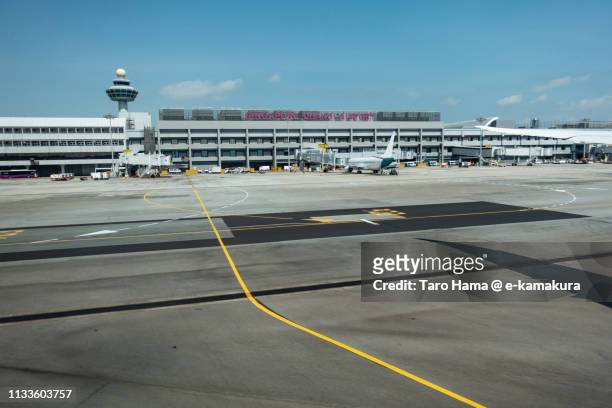 the airplane stopping at the terminal of singapore changi airport - changi stock pictures, royalty-free photos & images