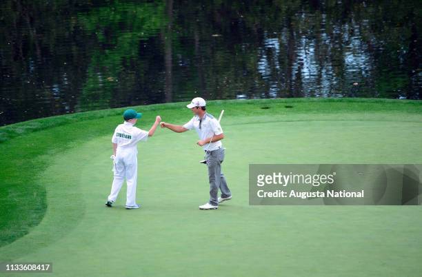 Kevin Streelman celebrates with his caddie Ethan Couch on the No. 9 to win in a playoff during the Par 3 Contest for the Masters at Augusta National...