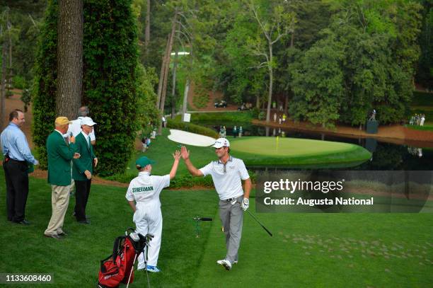 Winner Kevin Streelman high-fives his caddie Ethan Couch on No. 9 during the Par 3 Contest for the Masters at Augusta National on Wednesday, April 8,...