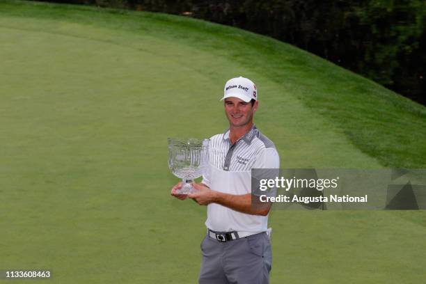 Winner Kevin Streelman accepts the Crystal Pedestal Bowl with his caddie Ethan Couch after the Par 3 Contest for the Masters at Augusta National on...