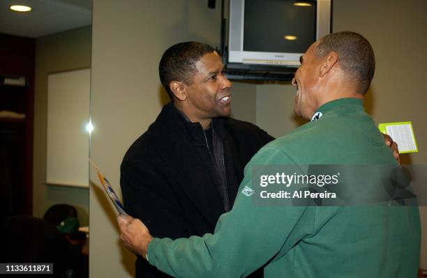 Actor Denzel Washington meets with New York Jets Head Coach Herm Edwards in the locker room when he attends the New York Jets v Seattle Seahawks game...