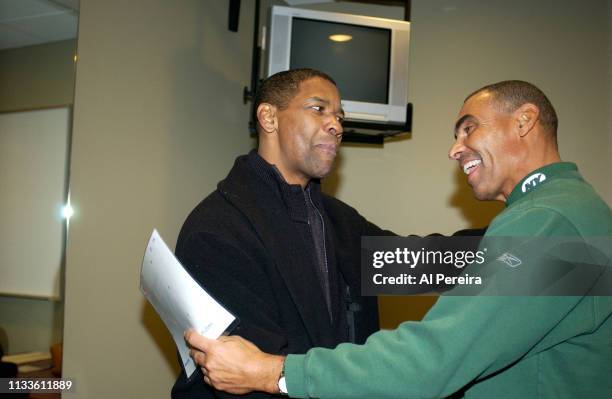 Actor Denzel Washington meets with New York Jets Head Coach Herm Edwards in the locker room when he attends the New York Jets v Seattle Seahawks game...