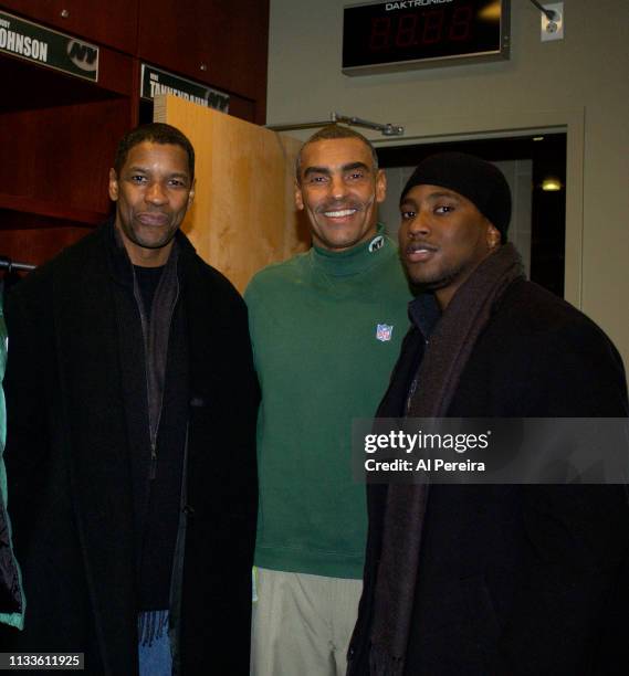 Actor Denzel Washington and his son, John David Washington, meet with New York Jets Head Coach Herm Edwards in the locker room when he attends the...