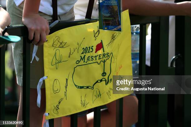 Detail of a souvenir pin marker flag with competitors' autographs during Practice Round 2 for the Masters at Augusta National on Tuesday, April 7,...