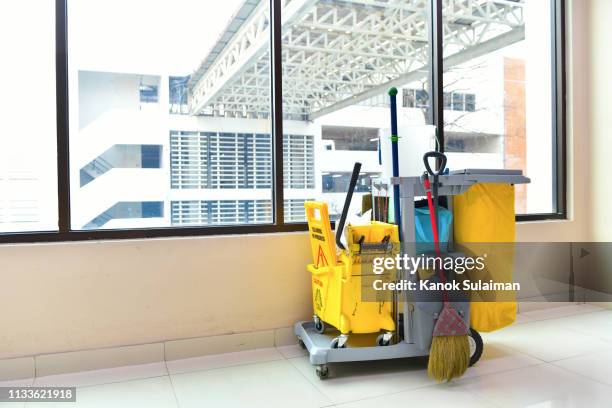 cleaning tools cart wait for cleaning,yellow mop bucket and set of cleaning equipment in the airport - office cleaning bildbanksfoton och bilder