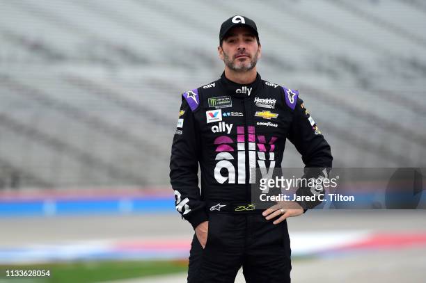 Jimmie Johnson, driver of the Ally Chevrolet, walks on the grid during qualifying for the Monster Energy NASCAR Cup Series O'Reilly Auto Parts 500 at...