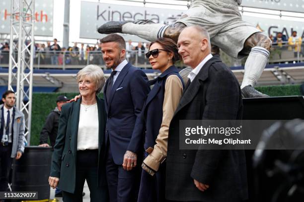 David Beckham poses with his wife Victoria Beckham and parents for a photo with his statue at Dignity Health Sports Park on March 02, 2019 in Carson,...