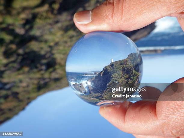 seascape seen through a crystal ball - mano umana stock pictures, royalty-free photos & images