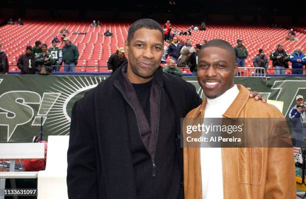 Actor Denzel Washington meets with New York Jets Cornerback Ray Mickens on the New York Jets sideline when he attends the New York Jets v Seattle...