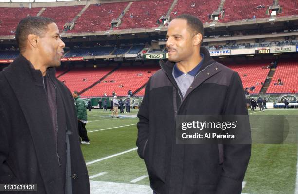 Actor Denzel Washington meets with former NFL Player Warren Moon on the New York Jets sideline when he attends the New York Jets v Seattle Seahawks...