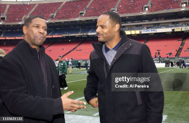 Actor Denzel Washington meets with former NFL Player Warren Moon on the New York Jets sideline when he attends the New York Jets v Seattle Seahawks...