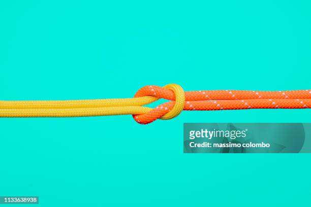 connection concepts with climbing ropes - man tying tie stock-fotos und bilder