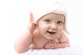 Cute adorable baby child with warm white hat .