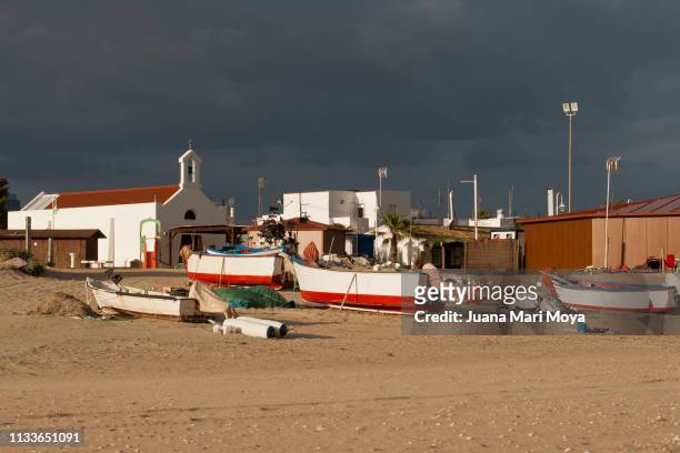 seascape, with fishing boats and a hermitage in islantilla.  huelva  spain - embarcación marina stock pictures, royalty-free photos & images