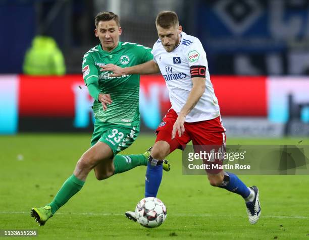 Aaron Hunt of Hamburg is challenged by Paul Seguin of Fuerth during the Second Bundesliga match between Hamburger SV and SpVgg Greuther Fuerth at...