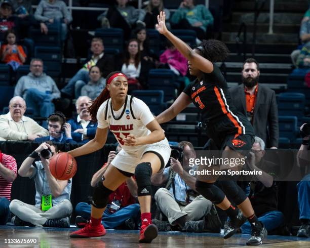 Louisville Cardinals Forward Bionca Dunham dribbles the ball against Oregon State Beavers Guard Madison Washington during the first half of the game...