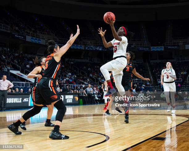 Louisville Cardinals Guard Jazmine Jones leaps for the basket with Oregon State Beavers Forward Taya Corosdale defending during the second half of...