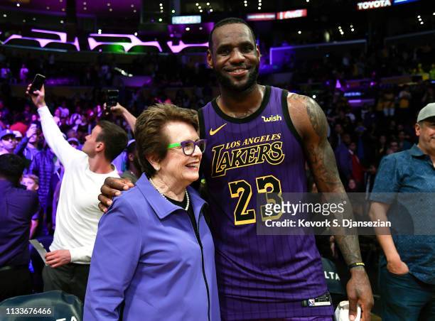 LeBron James of the Los Angeles Lakers is congratulated by tennis legend Billie Jean King after the Lakers defeated the Charlotte Hornets, 129-15, at...