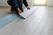 Worker carpenter doing laminate floor work