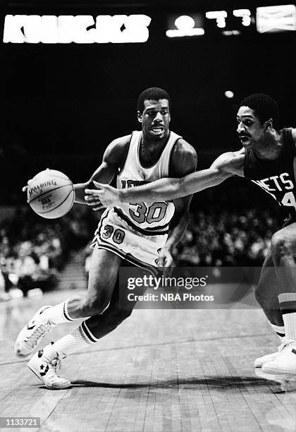 Bernard King of the New York Knicks dribbles against the New Jersey Nets during the NBA game at Madison Square Garden, New York City, New York. NOTE...