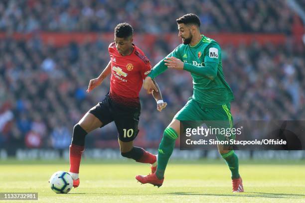 Marcus Rashford of Man Utd battles with Miguel Angel Britos of Watford during the Premier League match between Manchester United and Watford at Old...