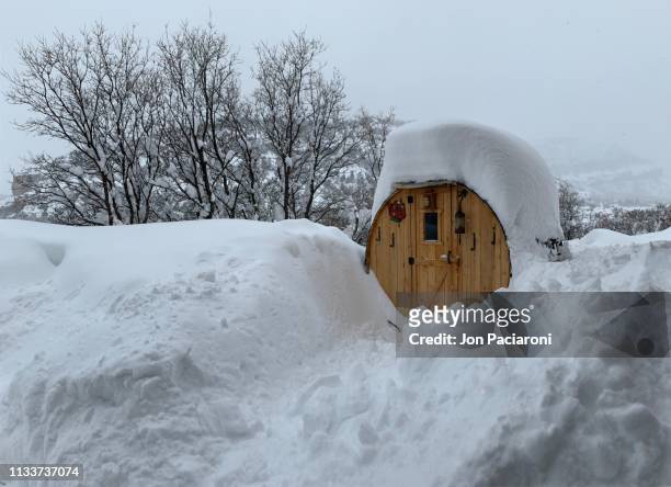 snow covered sauna in a colorado blizzard - sauna winter foto e immagini stock