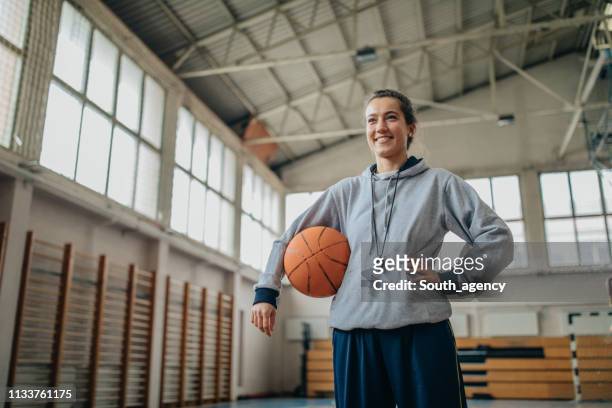 lady basketball coach on court with a ball - coach whistle stock pictures, royalty-free photos & images