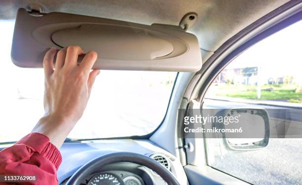man holding sun visor in car - visor stock pictures, royalty-free photos & images