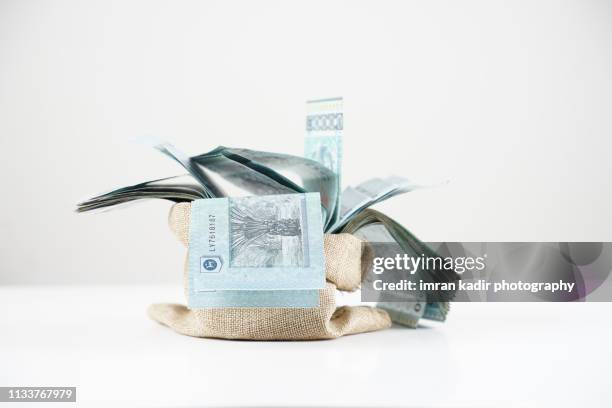 malaysian ringgit in sacks - malaysian ringgit stock pictures, royalty-free photos & images