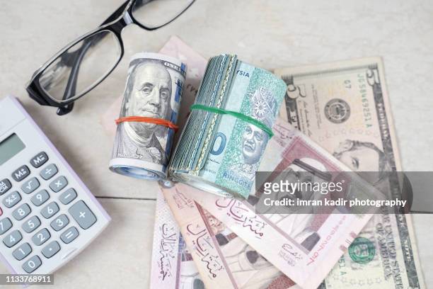 multiple banknote on wooden table - persian gulf stock pictures, royalty-free photos & images