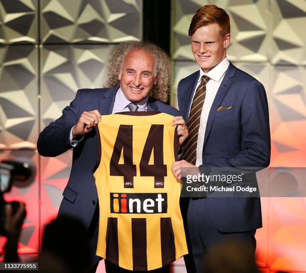 Damon Greaves of the Hawks accepts his jumper from former player John Platten during the Hawthorn Hawks AFL season launch at Melbourne Cricket Ground...