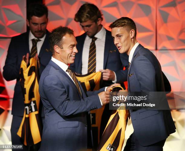 Harrison James of the Hawks accepts his jumper from Hawks head coach Alastair Clarkson during the Hawthorn Hawks AFL season launch at Melbourne...