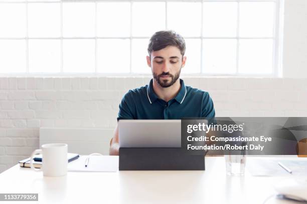 businessman using laptop in office - vanguardians ストックフォトと画像