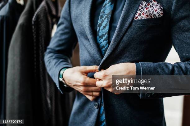 close-up of man buttoning up suit - sastre fotografías e imágenes de stock