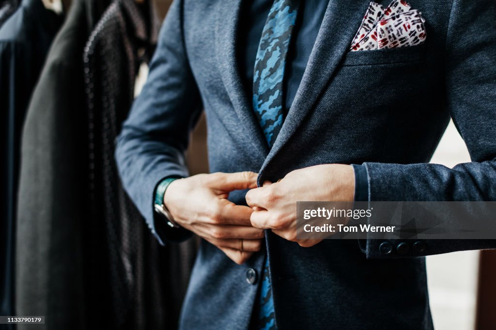 Close-Up Of Man Buttoning Up Suit