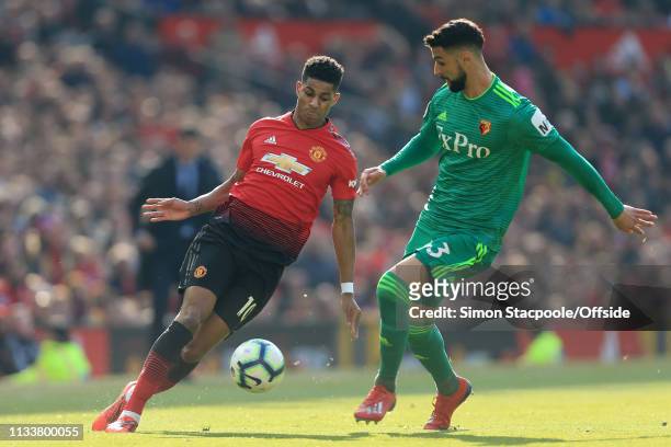 Marcus Rashford of Man Utd battles with Miguel Angel Britos of Watford during the Premier League match between Manchester United and Watford at Old...