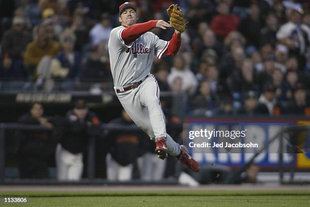 Third Baseman Scott Rolen of the Philadelphia Phillies leaps in the air after throwing the ball to first base against the San Francisco Giants during...