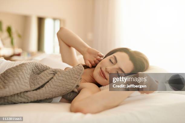 what a beautiful sleep that was - brunette woman bed stock pictures, royalty-free photos & images